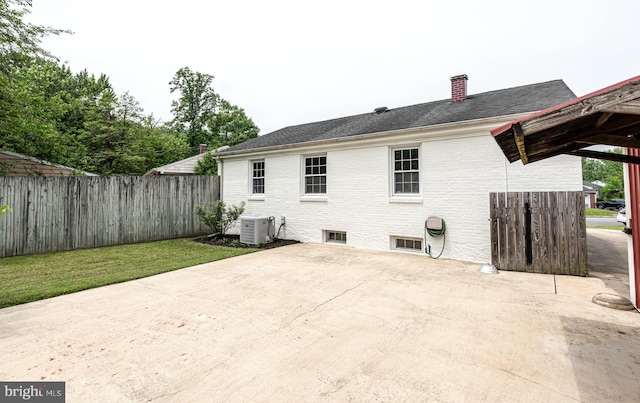 1006 Marleigh Cir, Baltimore, MD 21204 - rear view of house featuring a patio area, a chimney, and brick siding