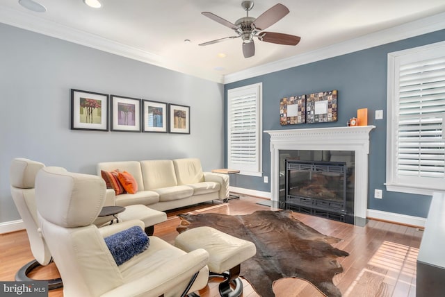 6139 Sligo Mill Rd NE, Washington, DC 20011 - living area featuring a ceiling fan, a fireplace with flush hearth, wood finished floors, baseboards, and crown molding