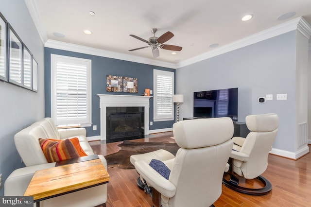 6139 Sligo Mill Rd NE, Washington, DC 20011 - living room featuring ceiling fan, wood finished floors, a glass covered fireplace, baseboards, and crown molding