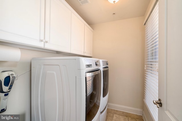 6139 Sligo Mill Rd NE, Washington, DC 20011 - laundry room featuring washer and clothes dryer, cabinet space, baseboards, and light tile patterned flooring