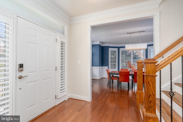 6139 Sligo Mill Rd NE, Washington, DC 20011 - foyer with wood finished floors, stairs, crown molding, track lighting, and wainscoting