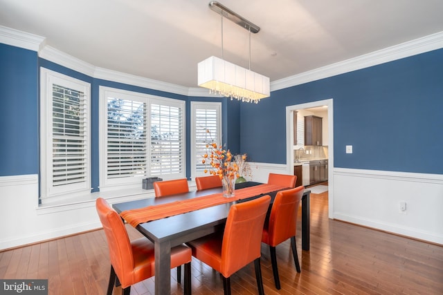 6139 Sligo Mill Rd NE, Washington, DC 20011 - dining space with ornamental molding, hardwood / wood-style floors, wainscoting, a chandelier, and baseboards