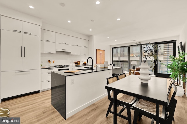 1500 Harry Thomas Way NE Unit 504, Washington, DC 20002 - kitchen featuring modern cabinets, white cabinetry, light wood-style flooring, and recessed lighting