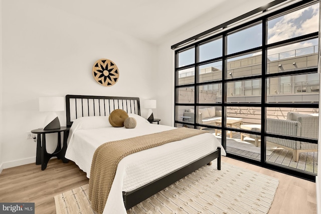 1500 Harry Thomas Way NE Unit 504, Washington, DC 20002 - bedroom featuring baseboards and wood finished floors