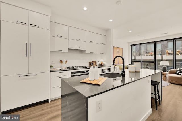 1500 Harry Thomas Way NE Unit 504, Washington, DC 20002 - kitchen featuring light wood-type flooring, modern cabinets, white cabinets, and recessed lighting