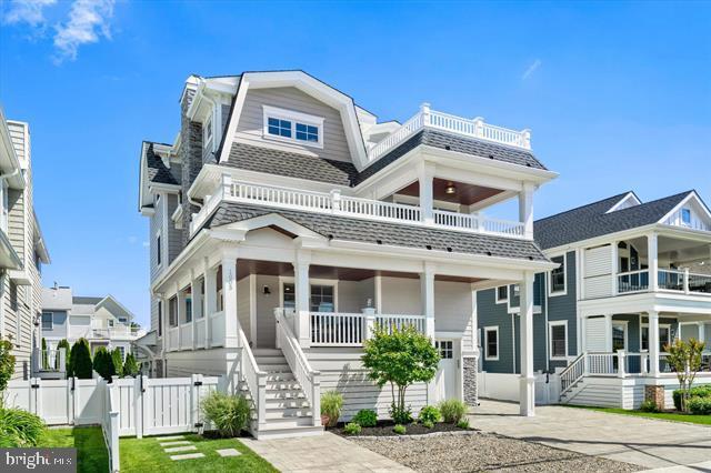 1005 Dune Dr, Avalon, NJ 08202 - view of front of house featuring a gate, a balcony, covered porch, a gambrel roof, and stairs