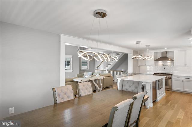 1005 Dune Dr, Avalon, NJ 08202 - dining area featuring a chandelier and light wood-style flooring