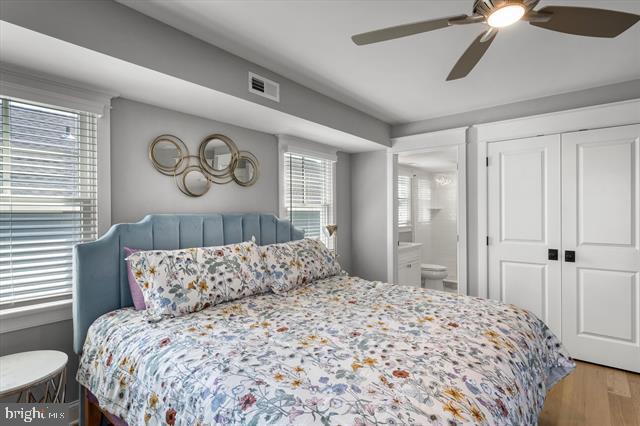 1005 Dune Dr, Avalon, NJ 08202 - bedroom featuring wood finished floors, ceiling fan, a closet, and ensuite bath