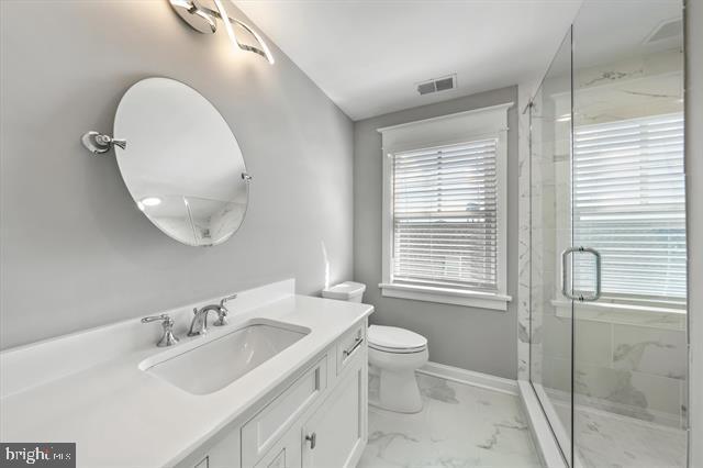 1005 Dune Dr, Avalon, NJ 08202 - bathroom with marble finish flooring, vanity, and a marble finish shower