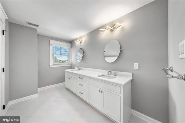 1005 Dune Dr, Avalon, NJ 08202 - full bathroom featuring double vanity and baseboards