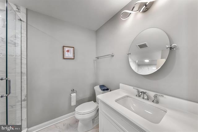 1005 Dune Dr, Avalon, NJ 08202 - bathroom featuring marble look tiles, a stall shower, and vanity