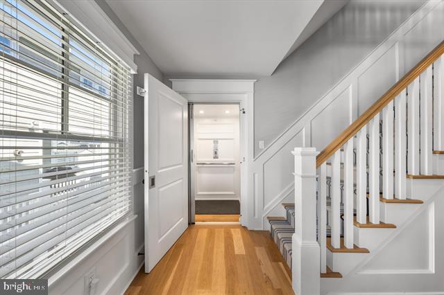 1005 Dune Dr, Avalon, NJ 08202 - entrance foyer with light wood-type flooring, stairway, and a decorative wall