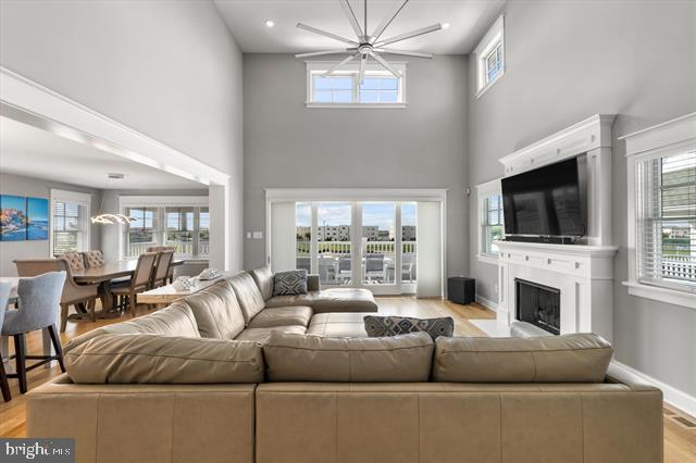1005 Dune Dr, Avalon, NJ 08202 - living area with a high ceiling, healthy amount of natural light, light wood-type flooring, a fireplace, and recessed lighting