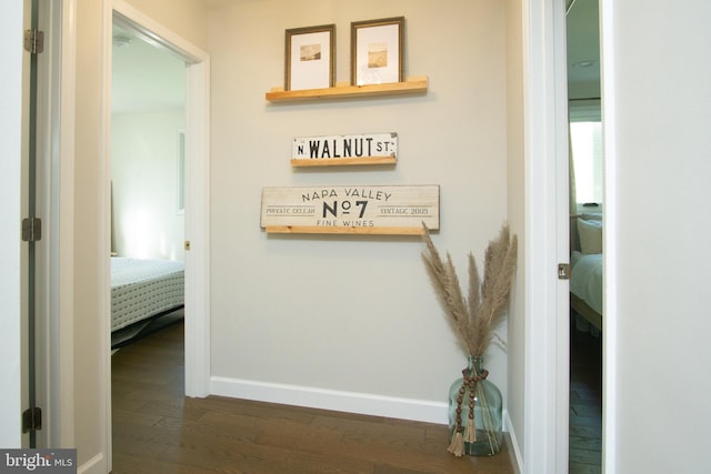 9007 Millers Island Blvd, Baltimore, MD 21219 - hallway with dark wood-style floors and baseboards