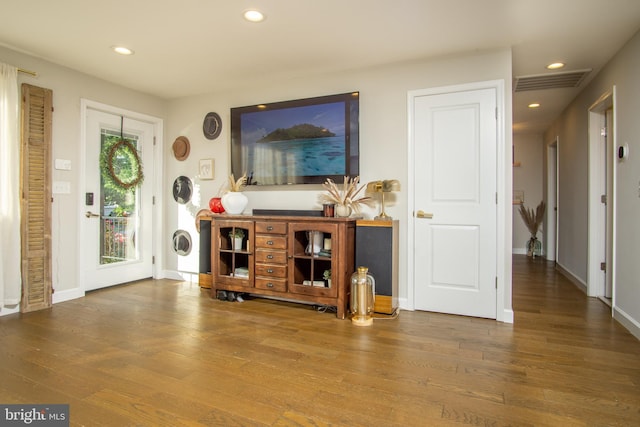 9007 Millers Island Blvd, Baltimore, MD 21219 - unfurnished living room featuring wood finished floors and recessed lighting