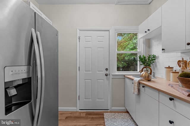 72 River St, Browns Mills, NJ 08015 - kitchen featuring stainless steel refrigerator with ice dispenser, light wood-style flooring, decorative backsplash, and white cabinets
