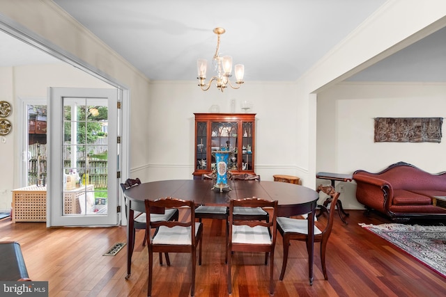 14519 Keeneland Cir, North Potomac, MD 20878 - dining space featuring a chandelier, wood finished floors, and ornamental molding