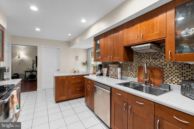 14519 Keeneland Cir, North Potomac, MD 20878 - kitchen with appliances with stainless steel finishes, light countertops, tasteful backsplash, light tile patterned floors, and brown cabinets