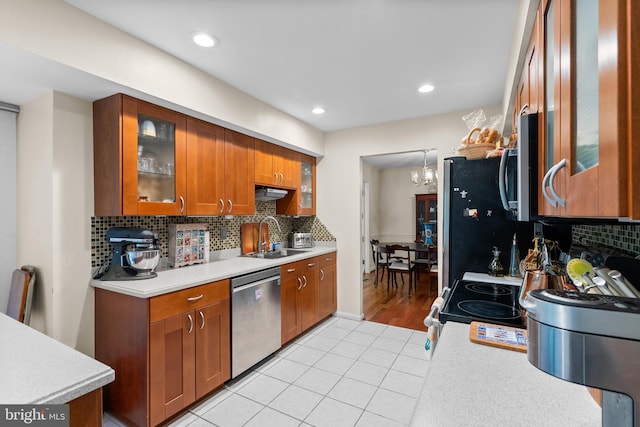 14519 Keeneland Cir, North Potomac, MD 20878 - kitchen with appliances with stainless steel finishes, brown cabinetry, light countertops, decorative backsplash, and recessed lighting
