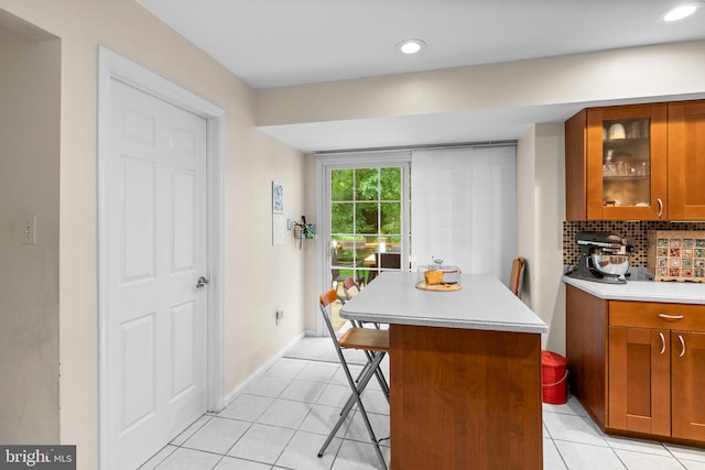 14519 Keeneland Cir, North Potomac, MD 20878 - kitchen featuring brown cabinets, light countertops, light tile patterned flooring, a breakfast bar, and recessed lighting