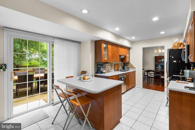 14519 Keeneland Cir, North Potomac, MD 20878 - kitchen with brown cabinets, light tile patterned flooring, dishwasher, light countertops, and recessed lighting