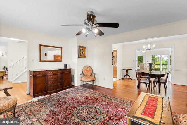 14519 Keeneland Cir, North Potomac, MD 20878 - living room with light wood finished floors, a chandelier, a ceiling fan, stairway, and crown molding