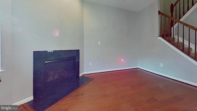 3515 Foundry Mews, Baltimore, MD 21211 - unfurnished living room with stairway, wood finished floors, and a glass covered fireplace
