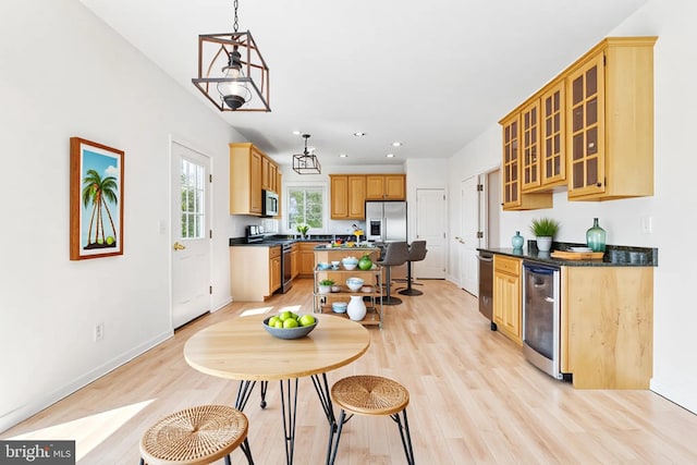 40461 Old Breton Beach Rd, Leonardtown, MD 20650 - kitchen with appliances with stainless steel finishes, dark countertops, a kitchen island, light wood-style flooring, and recessed lighting