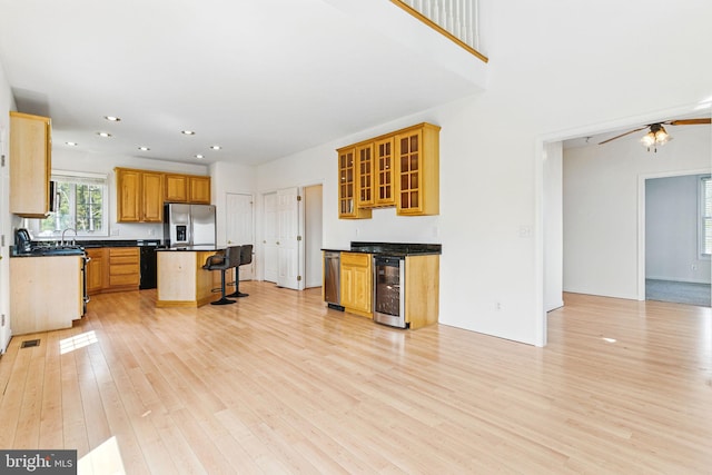 40461 Old Breton Beach Rd, Leonardtown, MD 20650 - kitchen with stainless steel refrigerator with ice dispenser, beverage cooler, light wood-style floors, a kitchen bar, and dark countertops