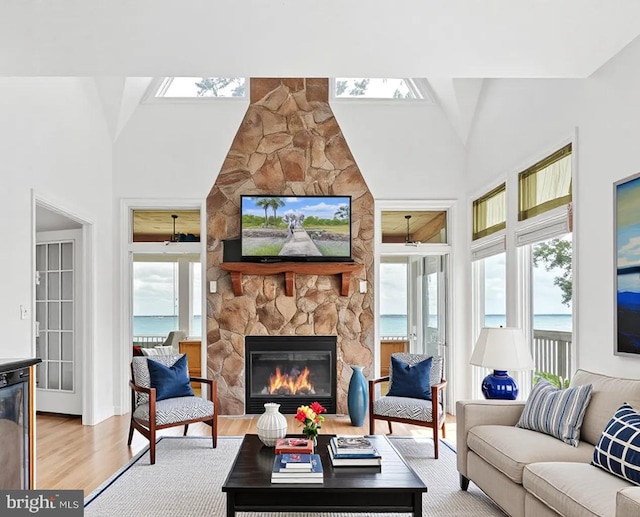 40461 Old Breton Beach Rd, Leonardtown, MD 20650 - living room with a skylight, plenty of natural light, a fireplace, and high vaulted ceiling