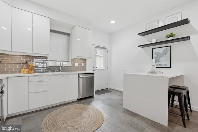 1002 S Colorado St, Philadelphia, PA 19146 - kitchen with dishwasher, white cabinetry, modern cabinets, backsplash, and light countertops