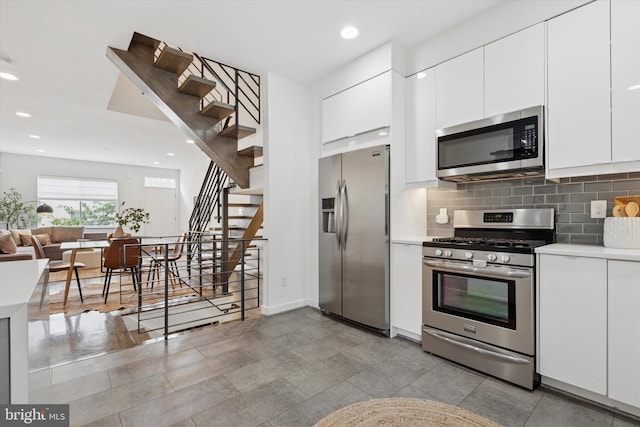 1002 S Colorado St, Philadelphia, PA 19146 - kitchen with appliances with stainless steel finishes, light countertops, backsplash, white cabinets, and recessed lighting