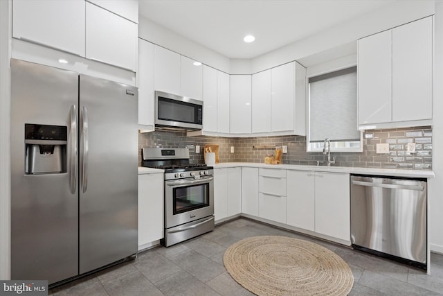 1002 S Colorado St, Philadelphia, PA 19146 - kitchen with appliances with stainless steel finishes, light countertops, white cabinets, tasteful backsplash, and modern cabinets