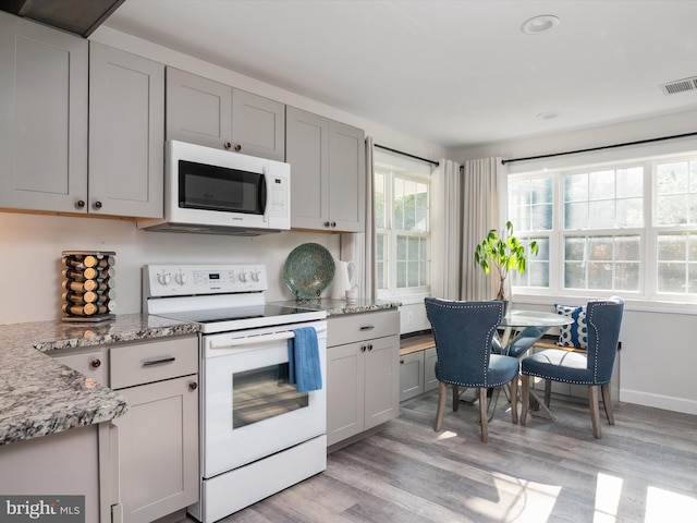 7802 Gary Ln, Severn, MD 21144 - kitchen with white appliances, light wood-style floors, light stone counters, gray cabinetry, and recessed lighting
