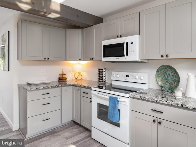 7802 Gary Ln, Severn, MD 21144 - kitchen featuring white appliances, light wood finished floors, and light stone countertops
