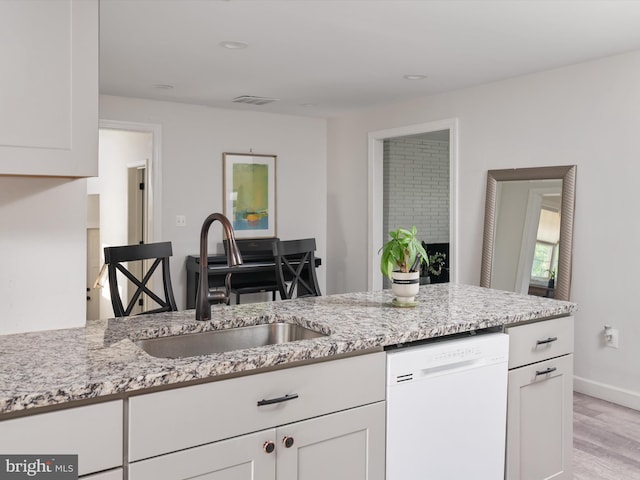 7802 Gary Ln, Severn, MD 21144 - kitchen with dishwasher, light stone countertops, white cabinets, light wood-style flooring, and recessed lighting