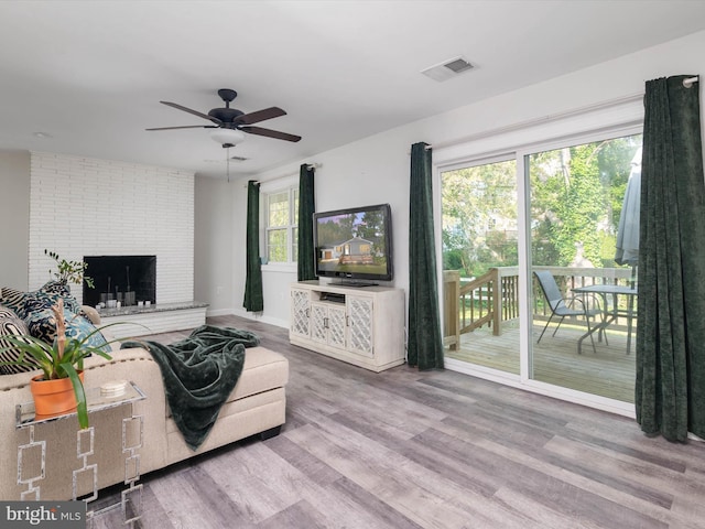 7802 Gary Ln, Severn, MD 21144 - living room featuring ceiling fan, wood finished floors, and a fireplace