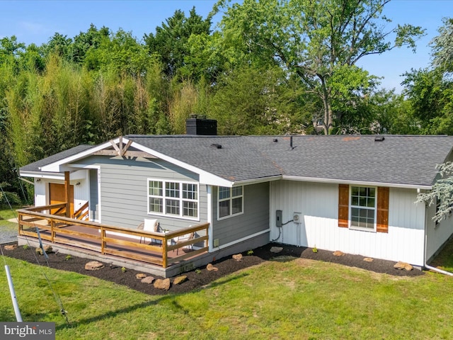 7802 Gary Ln, Severn, MD 21144 - rear view of house with a chimney, a deck, a yard, and a shingled roof