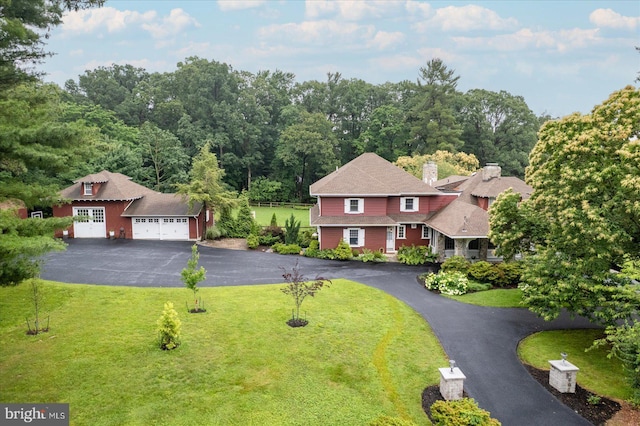 2165 Broadway, Hanover, PA 17331 - view of front of home with a front yard, a chimney, driveway, and a garage