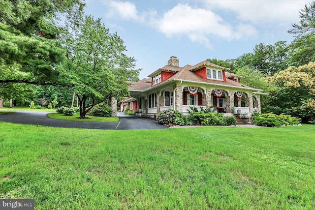 2165 Broadway, Hanover, PA 17331 - view of front of home featuring stone siding, a porch, a front yard, a chimney, and driveway