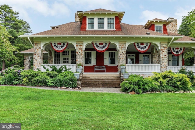 2165 Broadway, Hanover, PA 17331 - view of front of home featuring covered porch, a shingled roof, and a front lawn