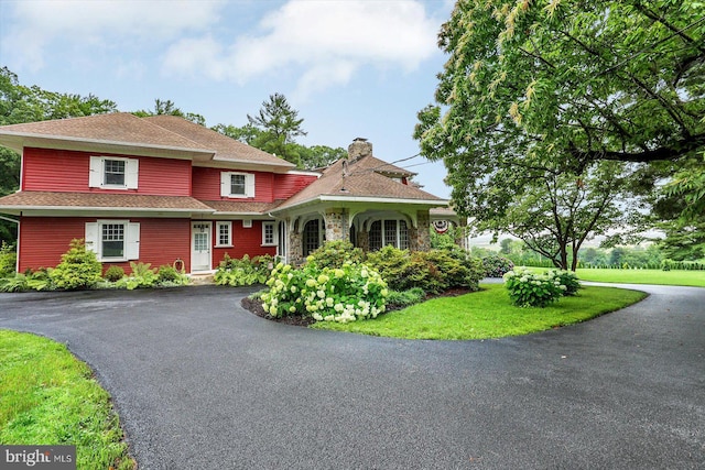 2165 Broadway, Hanover, PA 17331 - view of front of house featuring driveway, a chimney, roof with shingles, and stone siding