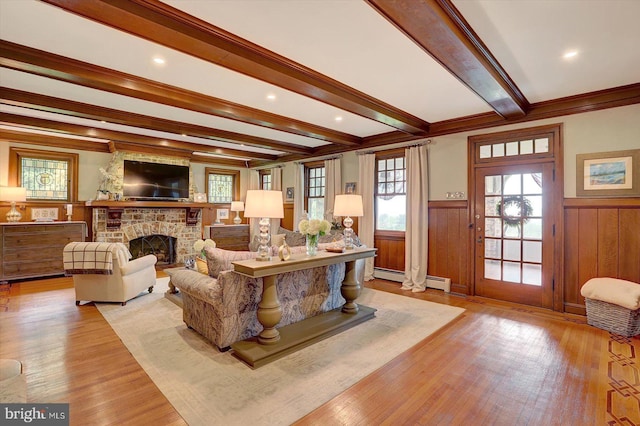 2165 Broadway, Hanover, PA 17331 - living area featuring beam ceiling, a brick fireplace, a wainscoted wall, light wood-style floors, and baseboard heating