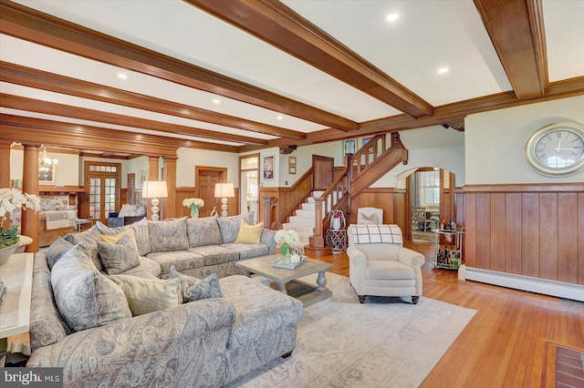 2165 Broadway, Hanover, PA 17331 - living room with a wainscoted wall, arched walkways, beam ceiling, stairs, and a baseboard radiator