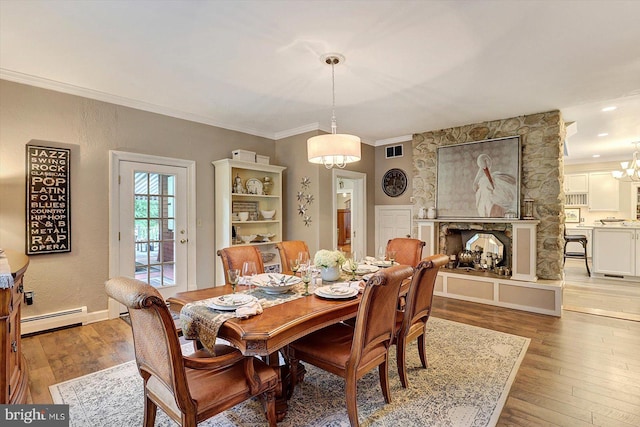 2165 Broadway, Hanover, PA 17331 - dining area with a baseboard radiator, a chandelier, light wood-type flooring, ornamental molding, and a fireplace