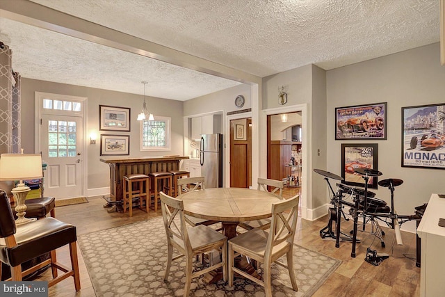 2165 Broadway, Hanover, PA 17331 - dining room featuring light wood-style floors, a textured ceiling, and a dry bar