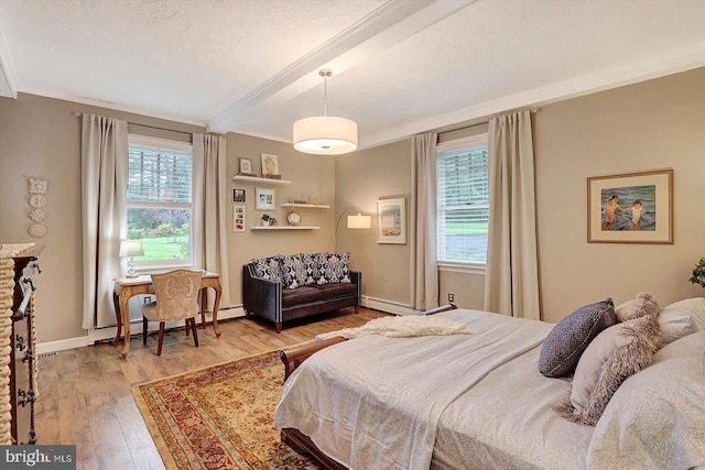 2165 Broadway, Hanover, PA 17331 - bedroom featuring beam ceiling, hardwood / wood-style flooring, crown molding, and a baseboard radiator
