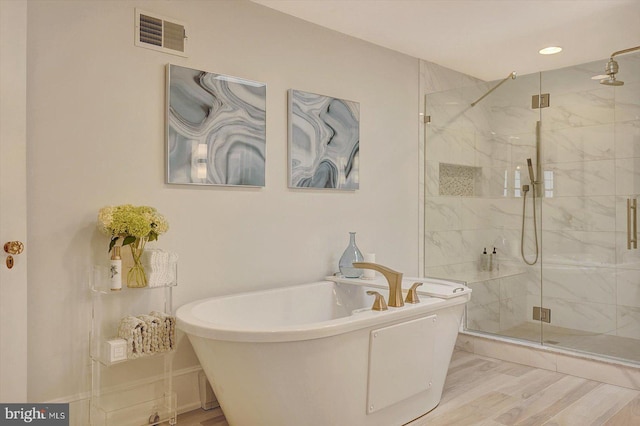 2165 Broadway, Hanover, PA 17331 - full bathroom featuring a soaking tub, a marble finish shower, wood finished floors, and recessed lighting