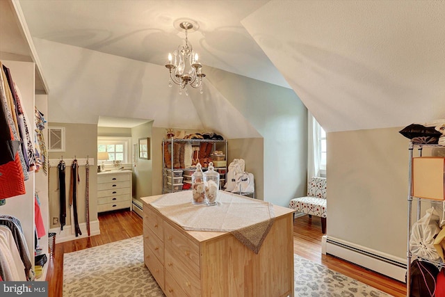 2165 Broadway, Hanover, PA 17331 - walk in closet featuring baseboard heating, light wood-style floors, vaulted ceiling, and a chandelier