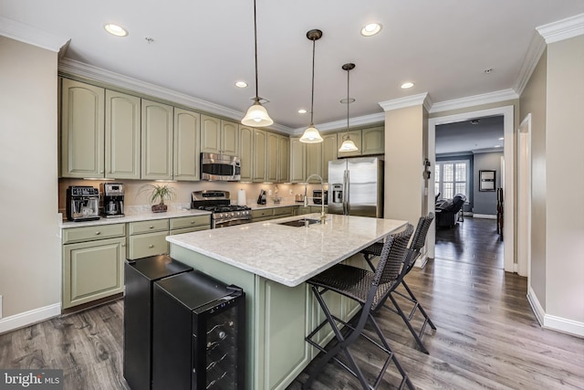 508 Rampart Way Unit 6, Oxon Hill, MD 20745 - kitchen featuring appliances with stainless steel finishes, wood finished floors, ornamental molding, a kitchen breakfast bar, and a kitchen island with sink